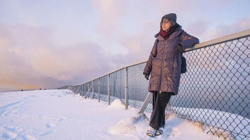 Rear view of woman walking on snow