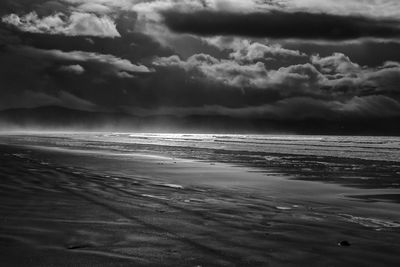 Scenic view of sea against storm clouds