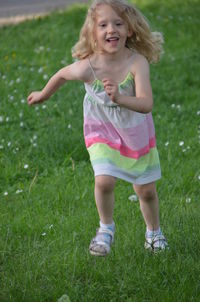 Girl playing on grassy field