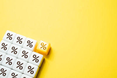 Close-up of toy blocks on yellow background