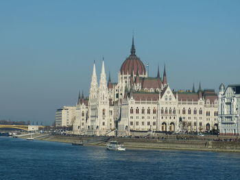 Buildings in city against clear sky