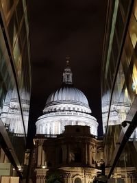 Low angle view of illuminated buildings against sky at night