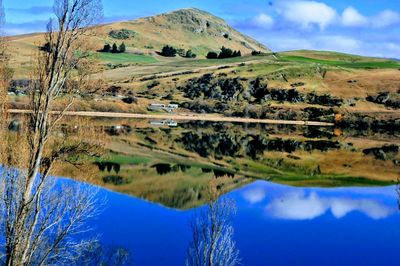 Scenic view of landscape and lake against sky