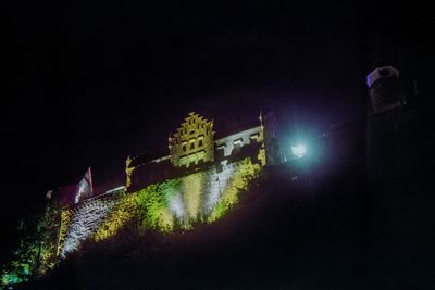 Illuminated city against sky at night