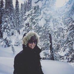 Portrait of smiling young woman in snow