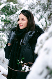 Portrait of young woman standing on snow