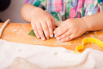 Midsection of boy doing craft on table