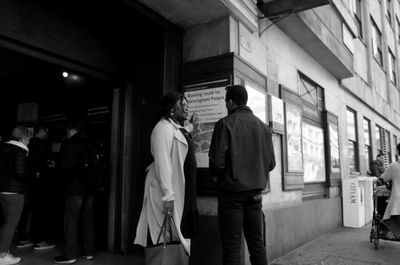 Rear view of people walking in bus