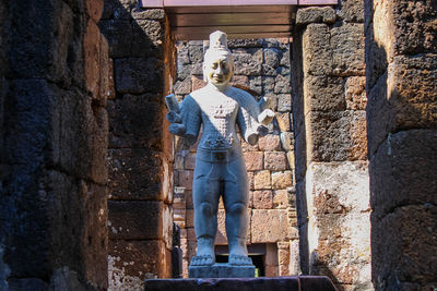 Rear view of man standing against wall