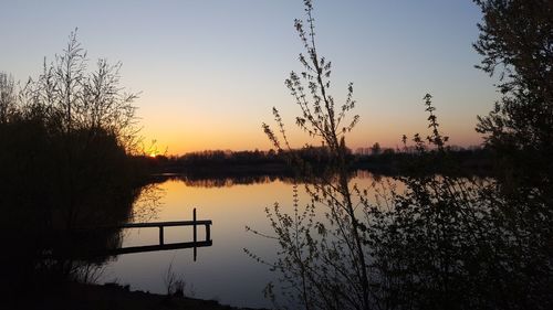 Scenic view of lake against sky during sunset