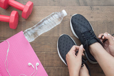 Low section of woman lying on hardwood floor