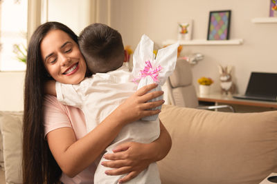 Side view of mother and daughter at home