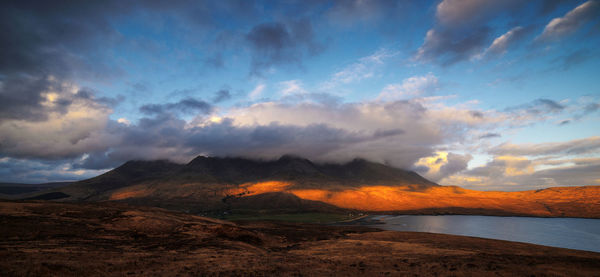 Scenic view of mountains against cloudy sky