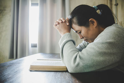 Woman pray for god blessing to wishing have a better life. 