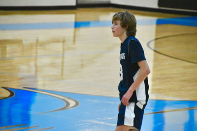 Full length of young boy playing basketball