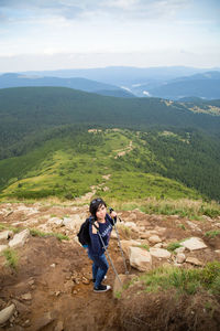 Full length of man photographing against mountains