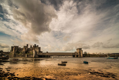 Conwy castle by river against sky