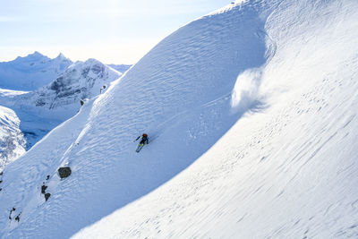 High angle view of young man skiing on snow covered mountain