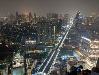 High angle view of illuminated city buildings at night