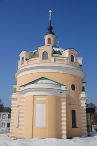 Low angle view of building against clear blue sky