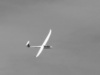 Low angle view of airplane flying in sky