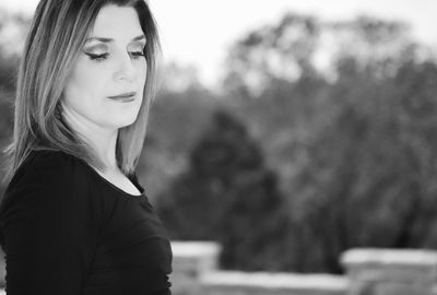 Portrait of young woman looking away outdoors