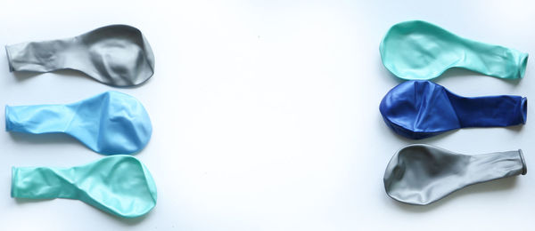 Directly above shot of helium balloons on white background