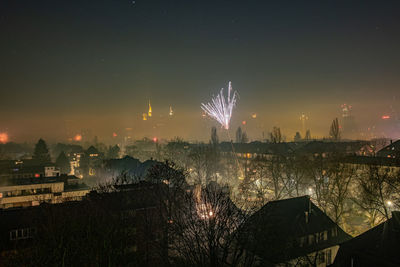 Panoramic shot of illuminated cityscape against sky at night