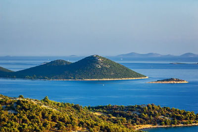 Scenic view of sea and mountains against sky