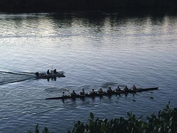Men rowing boat in river