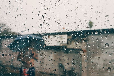 Full frame shot of wet glass window in rainy season