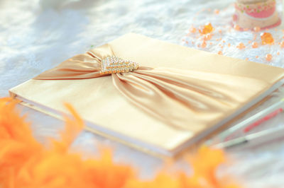 Close-up of book with tied ribbon on table