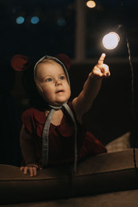 Toddler baby girl in funny hat with ears having fun