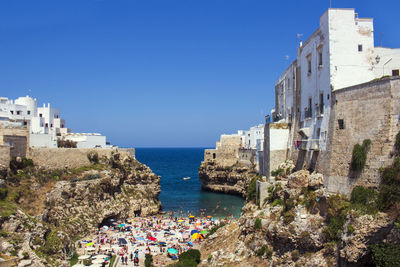 Panoramic view of sea and buildings against clear blue sky