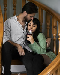 Young woman sitting on sofa at home