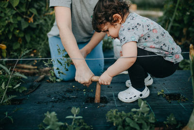 Full length of mother and daughter gardening