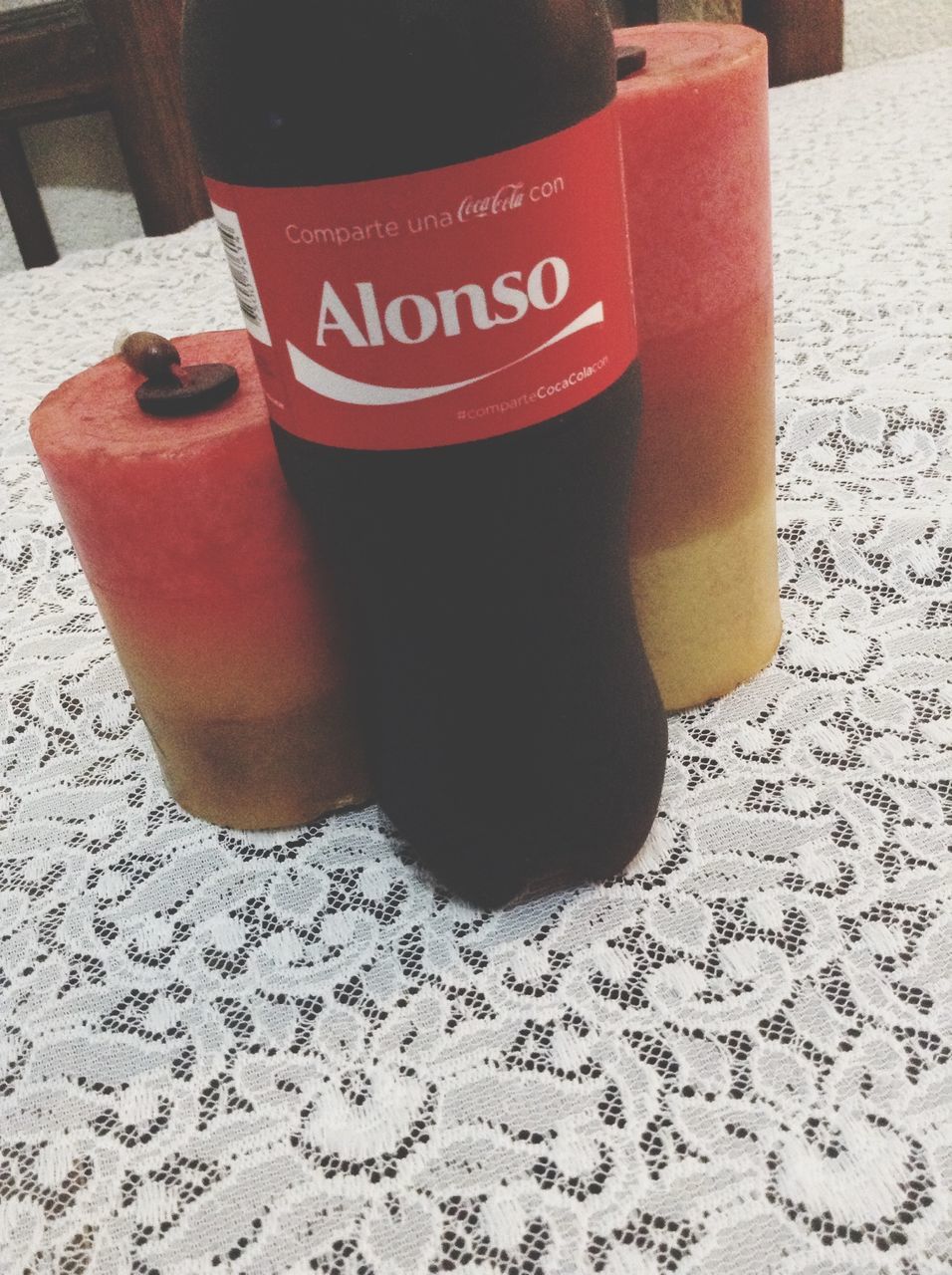 indoors, text, red, table, high angle view, still life, food and drink, close-up, communication, western script, drink, day, shadow, sunlight, refreshment, non-western script, person