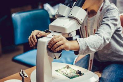 Midsection of man holding food on table