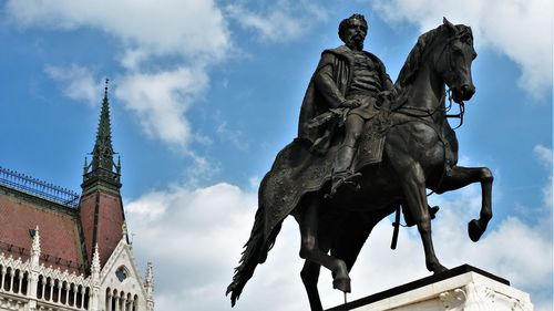 Low angle view of statue against cloudy sky