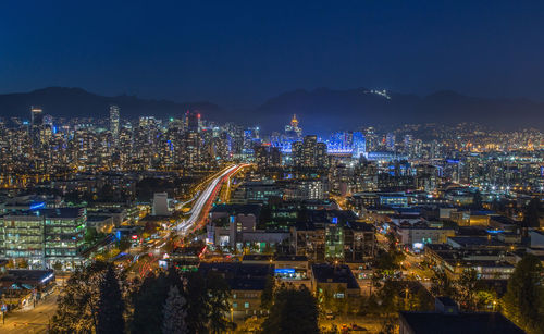 High angle view of illuminated city buildings at night