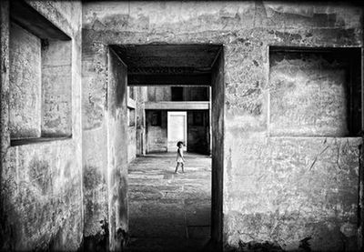 Full length of woman standing in front of building