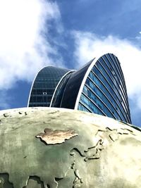 Low angle view of sculpture against cloudy sky