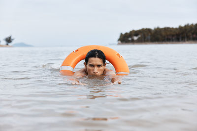 Portrait of boy swimming in sea