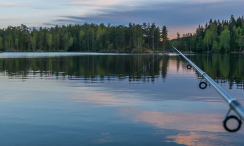 Scenic view of lake against sky at sunset