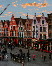 People on street against buildings in city