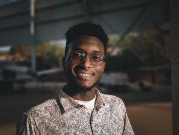 Portrait of smiling young man standing outdoors