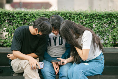 Side view of woman using mobile phone