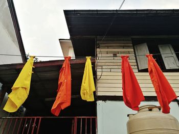 Low angle view of flags hanging against buildings
