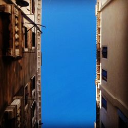 Low angle view of buildings against clear blue sky