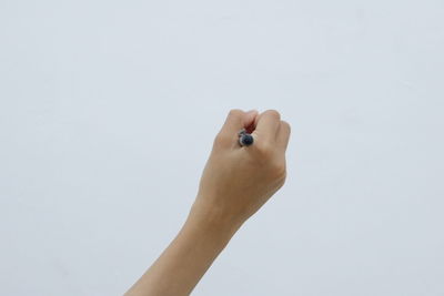 Close-up of woman hand against white background